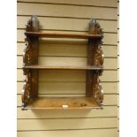 AN OAK THREE SHELF WALL RACK, the graduating shelves with decorative scroll fretwork sides and