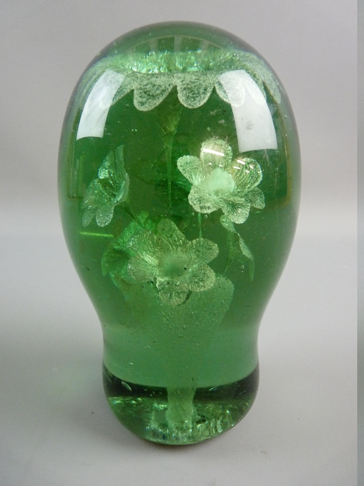 A LARGE VICTORIAN GREEN GLASS DUMP PAPERWEIGHT with interior flowers in a vase design and rough