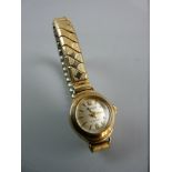 A LADY'S NINE CARAT GOLD ENCASED CIRCULAR DIAL REGENCY WRISTWATCH with expanding stainless steel and