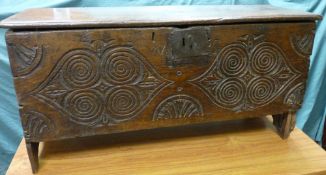 A CIRCA 1780 SIX PLANK CHEST with iron lock and carved front decoration, 53 cms high, 106.5 cms