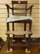 A LATE 18th/EARLY 19th CENTURY CHILD'S OAK HIGH ARMCHAIR, the rectangular top rail over four