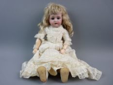 A KAMMER & REINHARDT BISQUE HEADED DOLL with blue sleep/open eyes, open mouthed with teeth and