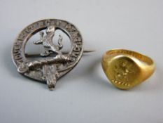 AN EIGHTEEN CARAT GOLD SIGNET RING, 5.5 grms with an engraved cat motif and a silver brooch on the