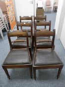 A SET OF SIX REGENCY MAHOGANY DINING CHAIRS, the curved top rail with carved decoration, central