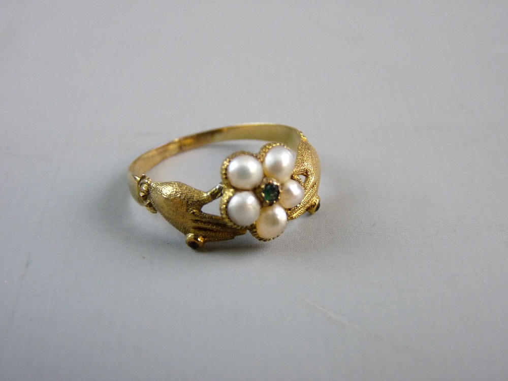 AN UNMARKED GOLD RING, the five centre pearls and tiny centre stone set and 'held' by two