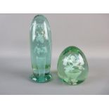 TWO VICTORIAN GREEN GLASS DUMP PAPERWEIGHTS, one 9 cms high with an internal vase and six flower