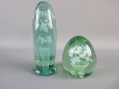 TWO VICTORIAN GREEN GLASS DUMP PAPERWEIGHTS, one 9 cms high with an internal vase and six flower