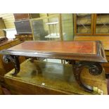 AN EMPIRE STYLE REPRODUCTION COFFEE TABLE with tooled leather top on curved carved supports with