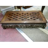 A LATE 19th CENTURY CARVED EASTERN HARDWOOD COFFEE TABLE, the top with pierced diamond decoration,