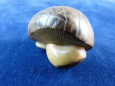 AN ORIENTAL NETSUKE in the form of a mushroom, signed