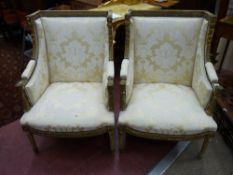 A PAIR OF LOUIS XVI STYLE ARMCHAIRS, gilt decorated with cream and gold classically styled
