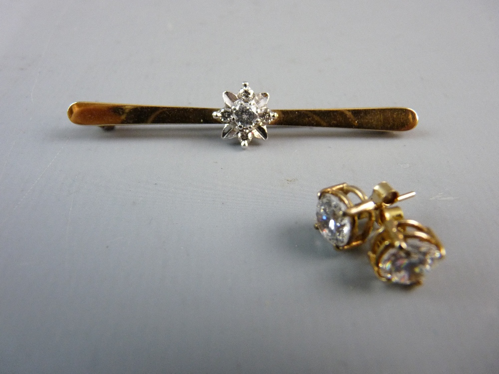 A NINE CARAT GOLD BAR BROOCH with floral centre having a diamond with visual estimate 0.3 carat
