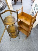 A NEAT OAK THREE SHELF OPEN BOOKCASE with decorated side panels and an Edwardian three tier