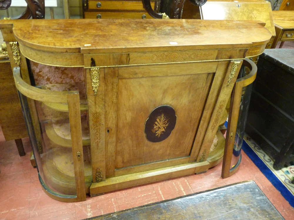 A VICTORIAN WALNUT BOWED CREDENZA with gilt metal embellishments, the shaped top over a central