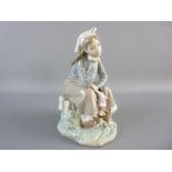 A LLADRO FIGURE of a young seated girl holding a doll with a basket of fruit by her side, no. C-