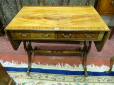 A REPRODUCTION CROSSBANDED MAHOGANY SOFA TABLE, twin flap ends flanking two frieze drawers on lyre