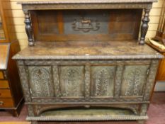 A GEORGE III AND LATER JACOBEAN STYLE SIDEBOARD, pollard and mixed period oak having a carved