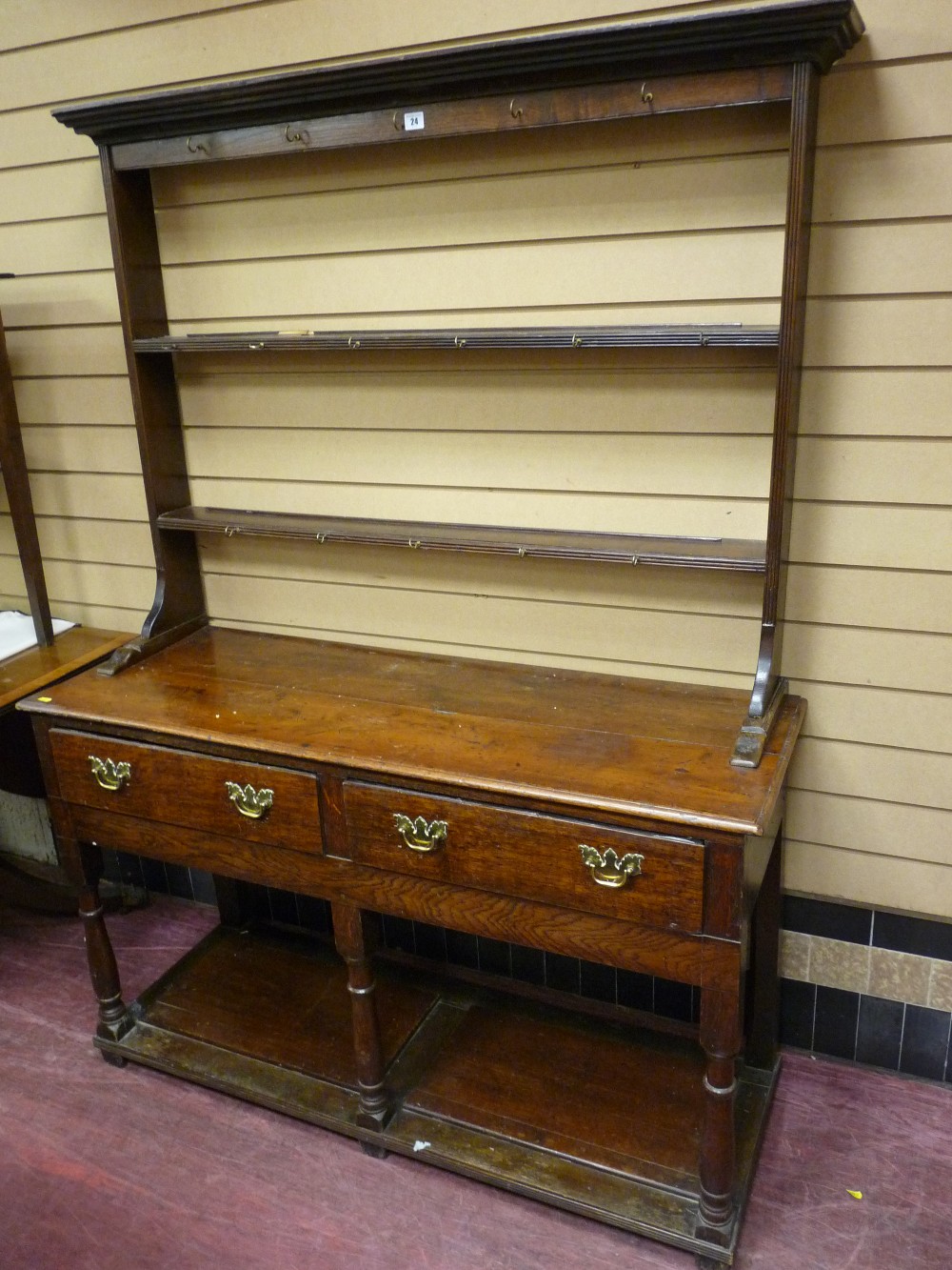 A GEORGE III OAK SOUTH WALES BORDERS DRESSER, neatly proportioned with two shelf open Delft rack