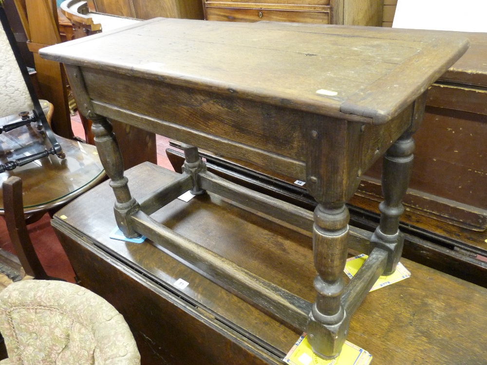 A VICTORIAN OAK BOX SEAT STOOL, the top with cleated ends on a peg joined base, on turned and