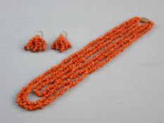A TRIPLE STRAND CORAL NECKLACE of crusty form with believed nine carat gold oblong plain clasp and a