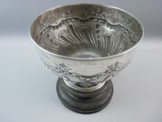 A GEORGE V HALLMARKED SILVER PUNCH BOWL on an ebonized circular stand, the 25.5 cms diameter bowl