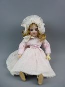 A LIMOGES BISQUE HEADED DOLL with blue paperweight eyes, open mouthed with teeth, painted detail and