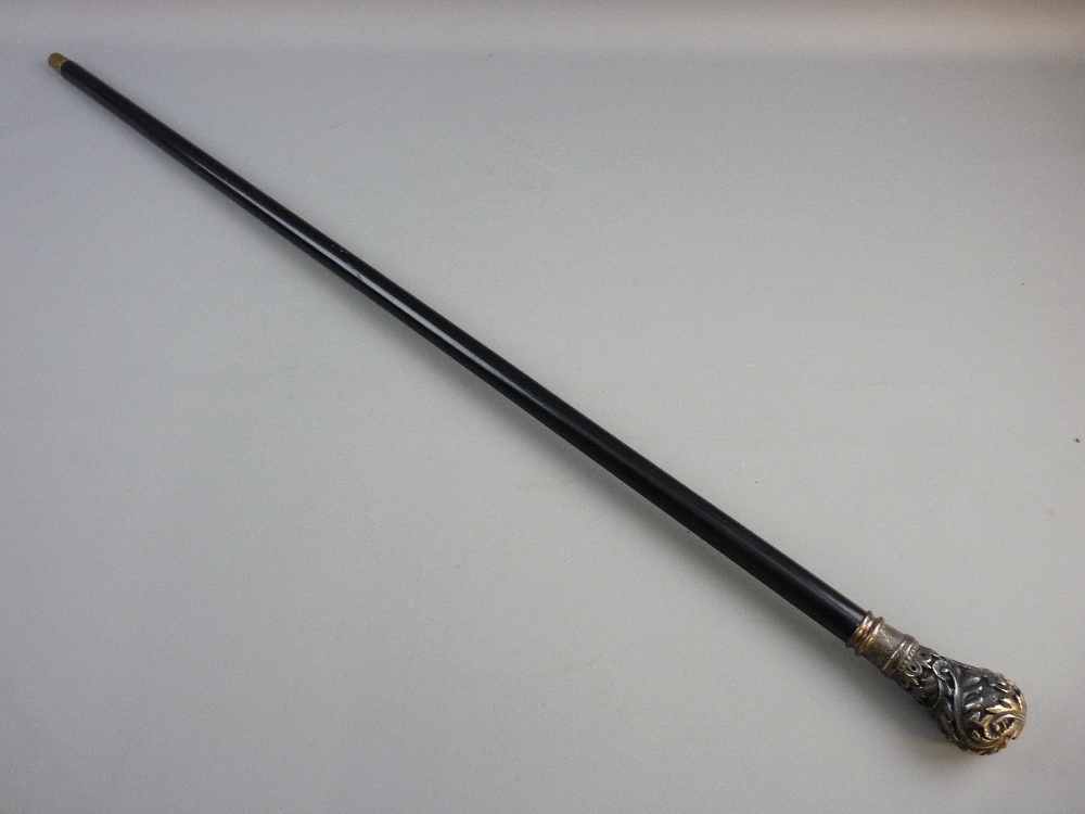 AN ANTIQUE EBONY WALKING CANE with decorative metal top, 92 cms long, the grip with crown topped