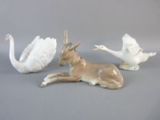 THREE LLADRO FIGURINES of a recumbent donkey, a swan model no. 6175 and a goose with outstretched