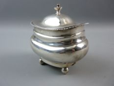 A GEORGE V HALLMARKED SILVER TEA CADDY with shaped bulbous body and lid, gadrooned border on ball