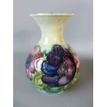 A MOORCROFT ANEMONE BULBOUS VASE, 16 cms high, having a flared rim in a tonal green ground,