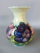 A MOORCROFT ANEMONE BULBOUS VASE, 16 cms high, having a flared rim in a tonal green ground,