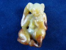 A CARVED CHINESE YELLOW AND RUSSET JADE MONKEY, 5.5 cms long