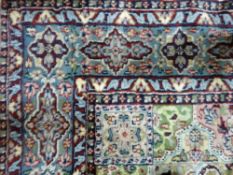 A 20th CENTURY EASTERN TASSELED EDGE WOOLLEN CARPET having a colourful central panel with a wide