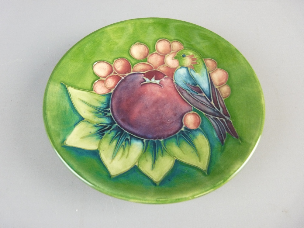 A BOXED MOORCROFT FINCH AND FRUIT PIN DISH by Sally Tuffin, 11.5 cms diameter, decorated on a