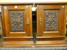 A PAIR OF EDWARDIAN MAHOGANY SINGLE DOOR WALL CABINETS with stepped cornice, central carved door