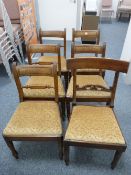 A SET OF FIVE REGENCY MAHOGANY DINING CHAIRS, the curved top rail with reeded sides, block and