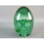 A LARGE VICTORIAN GREEN GLASS DUMP PAPERWEIGHT with unusual vase and seven flower interior design,