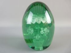 A LARGE VICTORIAN GREEN GLASS DUMP PAPERWEIGHT with unusual vase and seven flower interior design,