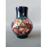A MOORCROFT ANEMONE BULBOUS VASE, 13 cms high, decorated on a cobalt ground, impressed to the