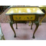 A REPRODUCTION BURR WALNUT LOWBOY with carved moulding, single frieze drawer with brass swing