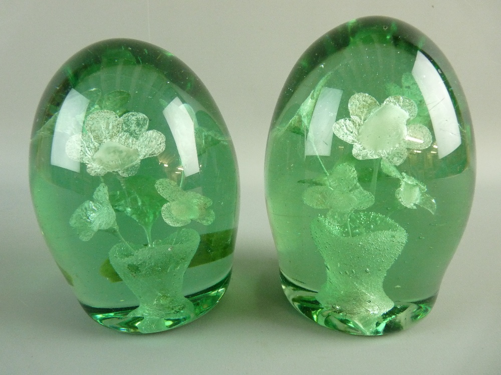 A NEAR PAIR OF VICTORIAN GREEN GLASS DUMP PAPERWEIGHTS with internal vase and six flower decoration,