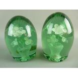 A NEAR PAIR OF VICTORIAN GREEN GLASS DUMP PAPERWEIGHTS with internal vase and six flower decoration,