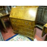 A 20th CENTURY WALNUT FALL FRONT BUREAU, the slope opening to reveal a gilt tooled green leather