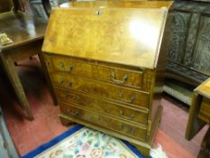 A 20th CENTURY WALNUT FALL FRONT BUREAU, the slope opening to reveal a gilt tooled green leather