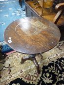 AN ANTIQUE OAK TRIPOD TABLE with 50 cms diameter top and a nest of three oak barley twist side