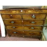 A GEORGE IV MAHOGANY CHEST of two short over three long drawers with Sheraton style inlay, oval