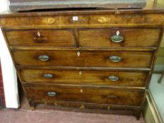 A GEORGE IV MAHOGANY CHEST of two short over three long drawers with Sheraton style inlay, oval