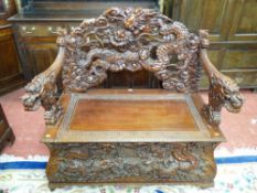 A HEAVILY CARVED ORIENTAL EXPORT BOX SEAT BENCH, profuse dragon decorated back, arms and box base