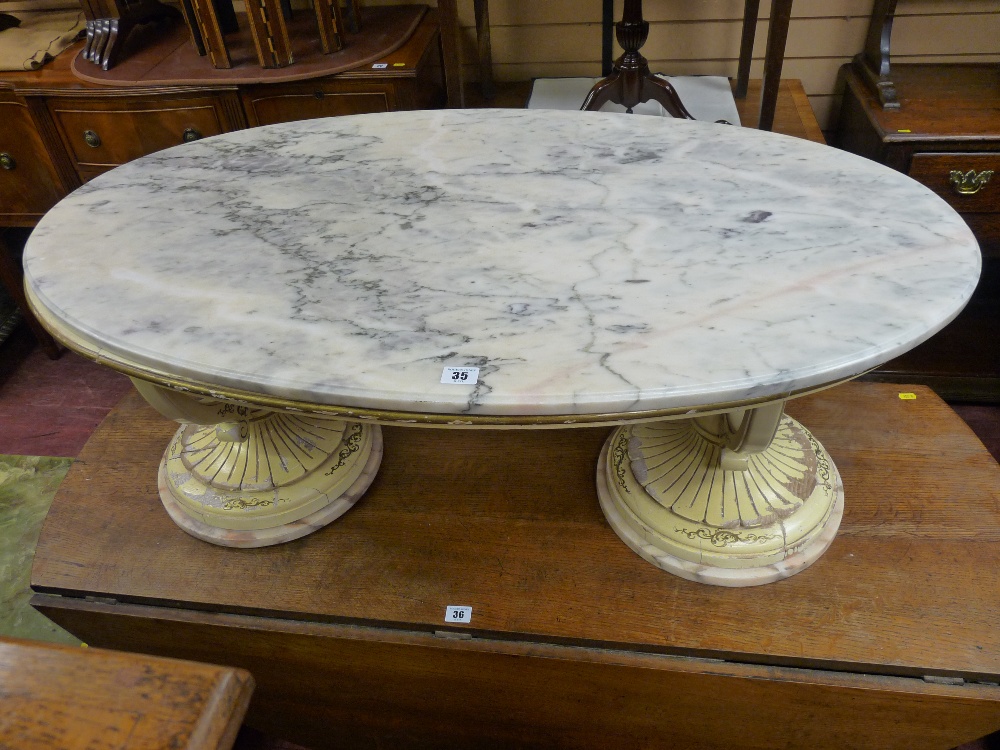 AN ITALIAN STYLE MARBLE TOP OVAL COFFEE TABLE with cream and gilt classical urn shaped base,