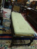 A CAROLEAN STYLE CARVED OAK DAY BED with floral crested top rail, barley twist and block supports,